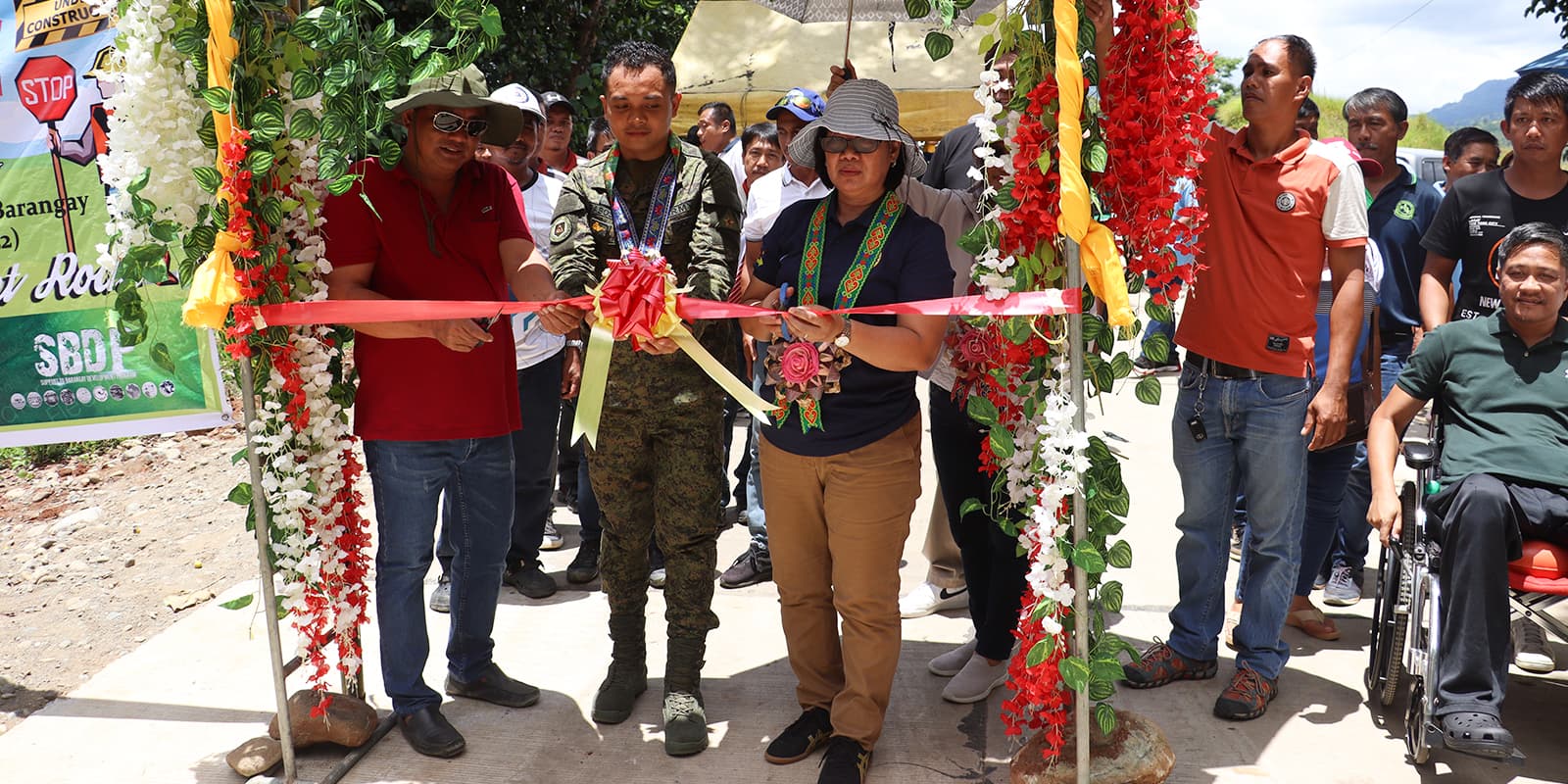 Hon. Rimel C. Tolentino (left), 1LT Nelson Rabosa (center), and DILG Regional Director Agnes A. De Leon (right) attend the ribbon cutting ceremony of one of the completed farm to market roads